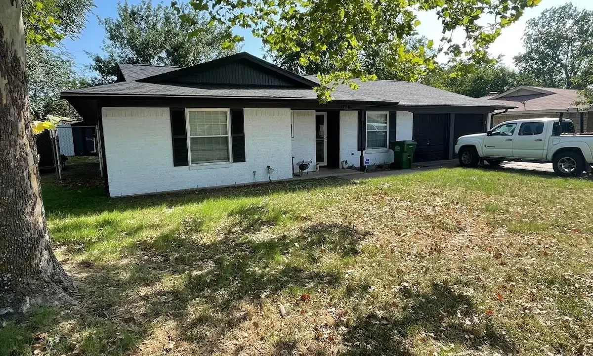 Professional roofing crew working on a residential roof in Bloomington